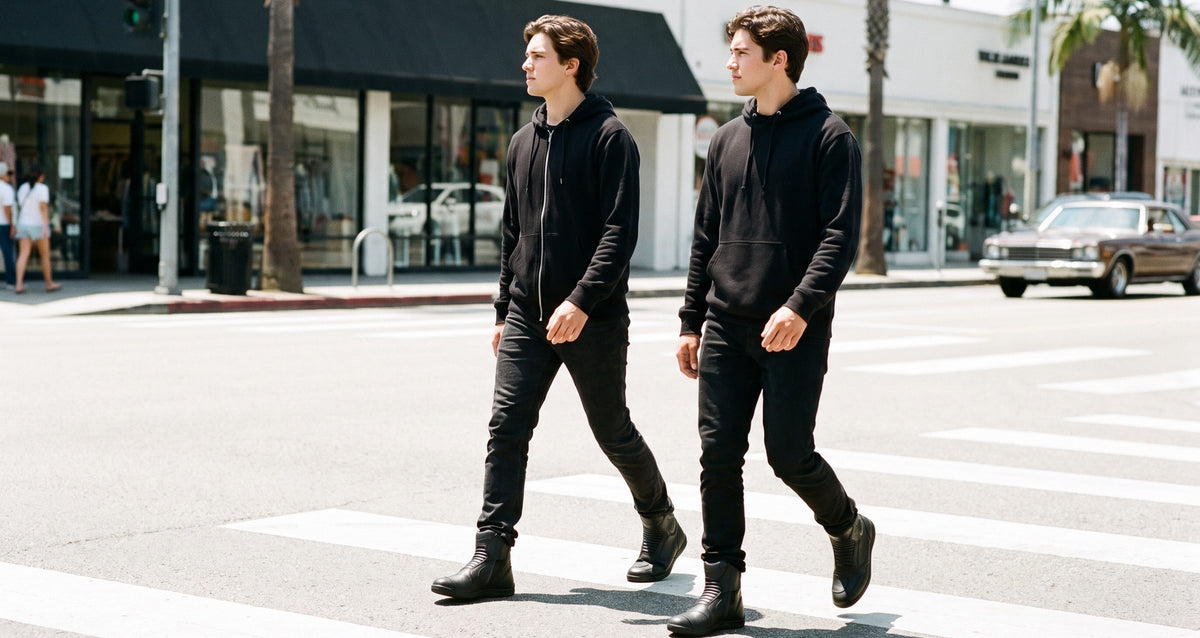 Two riders crossing a sunlit city street in low black leather riding shoes