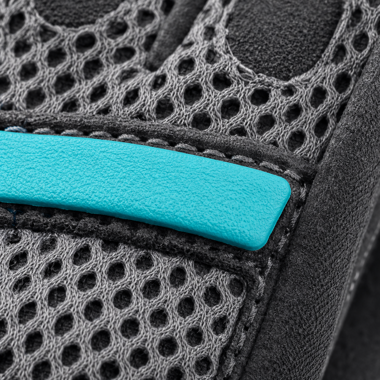 Close-up of CoreBreeze large-hole mesh, flex bar and stitching