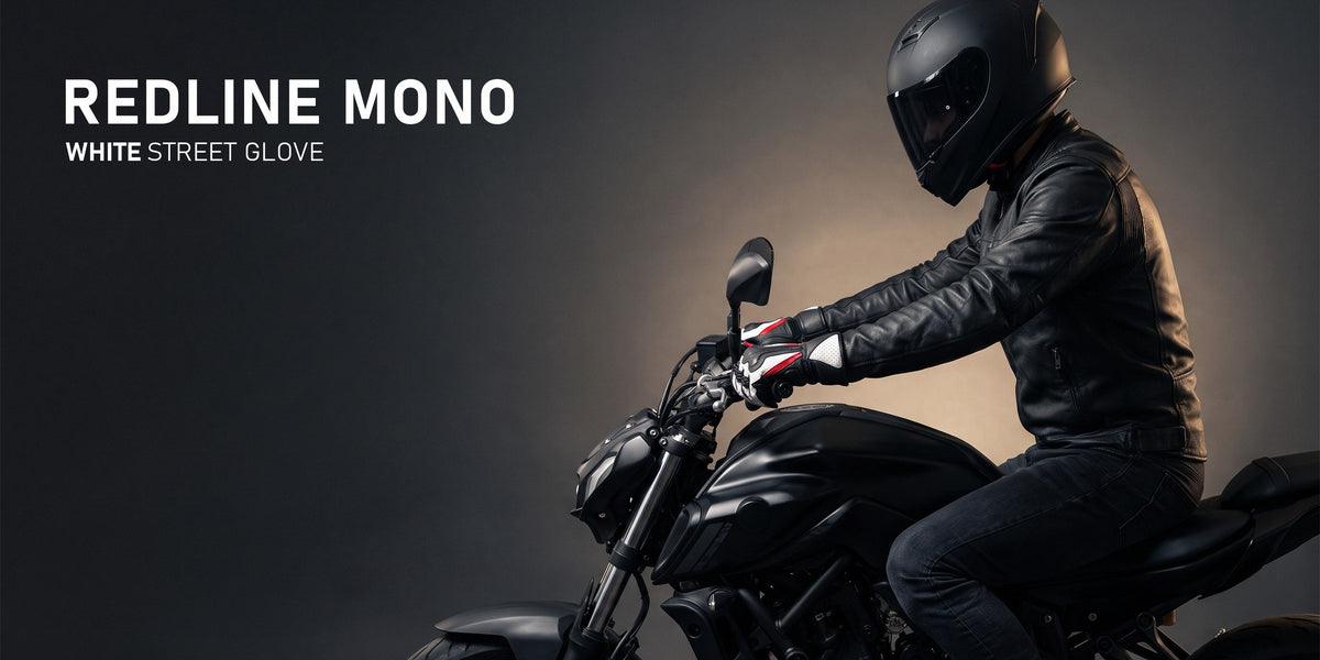 Redline Mono white street glove — rider on a matte black motorcycle in a dark studio