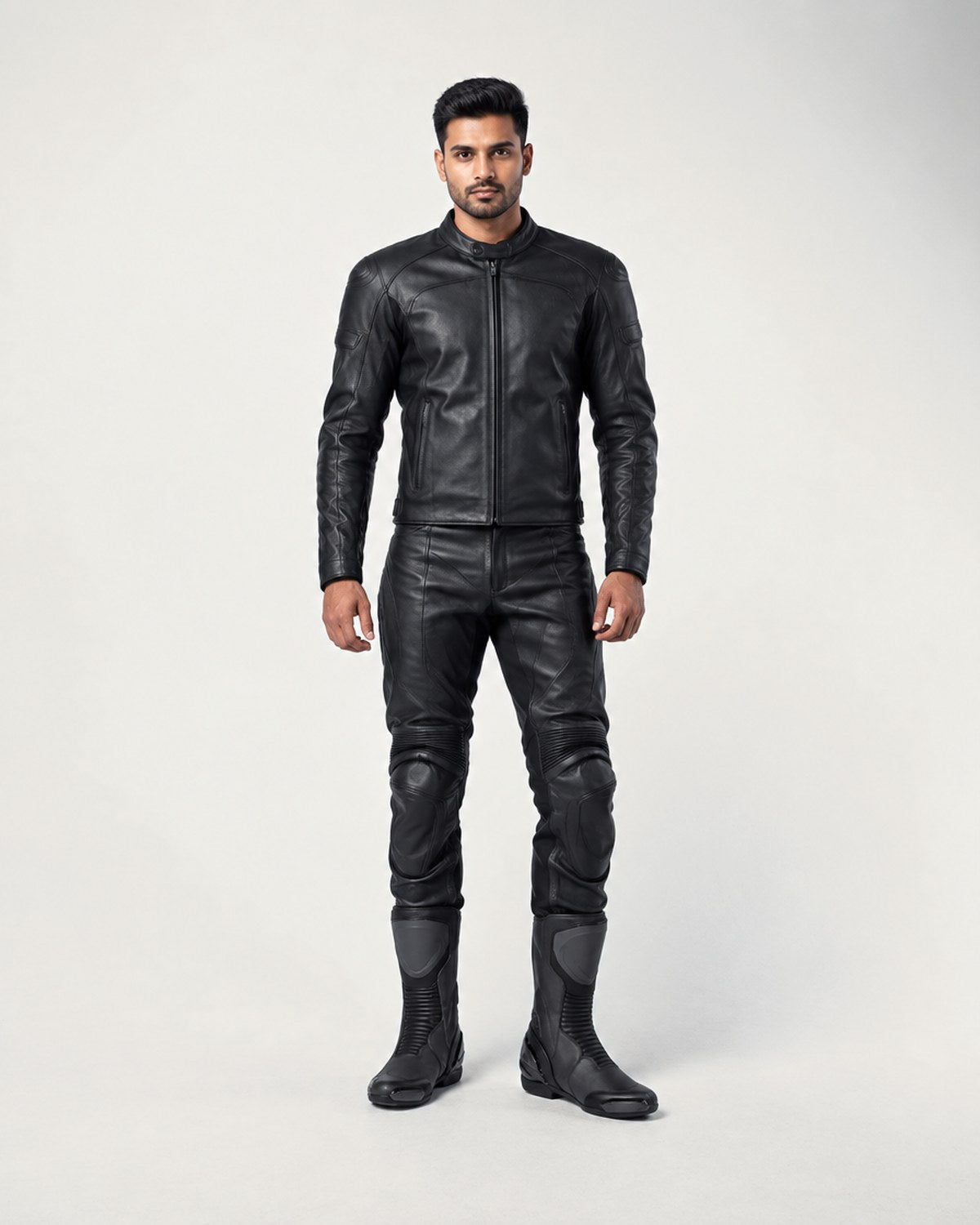 Model wearing black motorcycle racing boots in a grey studio